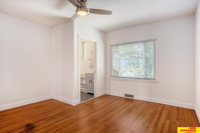 empty room with ceiling fan and hardwood / wood-style floors