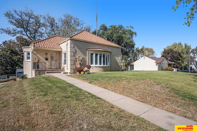 mediterranean / spanish-style home featuring a front yard