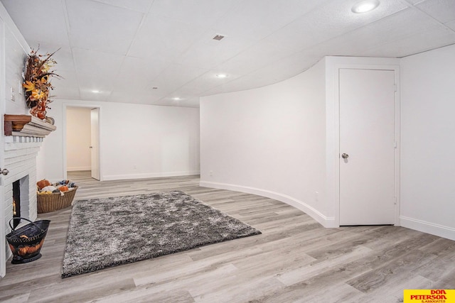 interior space with a fireplace and light wood-type flooring