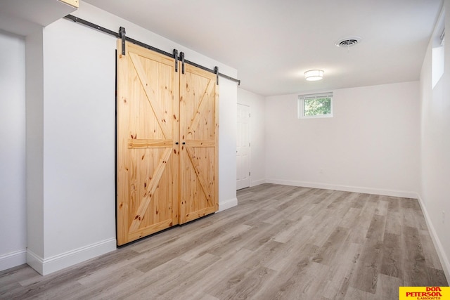 interior space featuring a barn door and light wood-type flooring