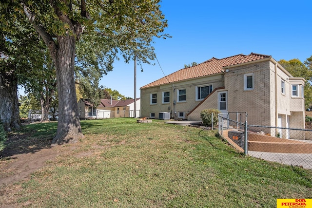 back of property featuring a yard