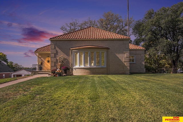 view of front of home with a yard