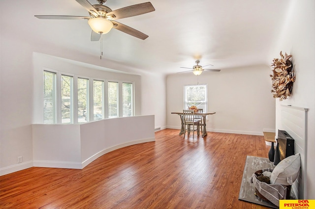 living room featuring ceiling fan and hardwood / wood-style floors