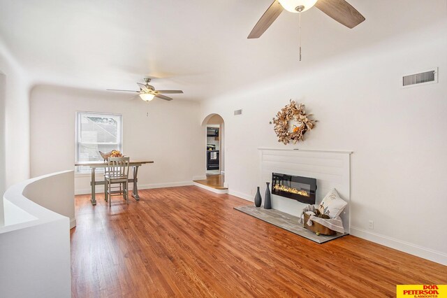 living room with ceiling fan and wood-type flooring