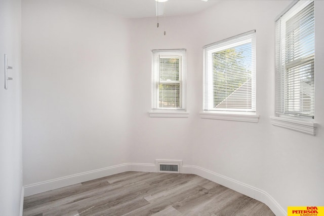 spare room featuring ceiling fan and light wood-type flooring