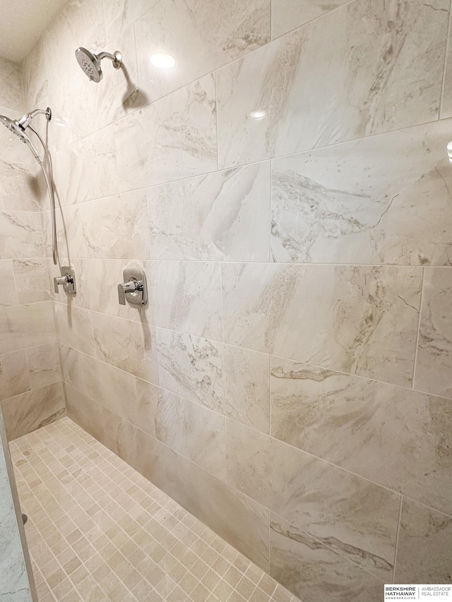 bathroom with a tile shower