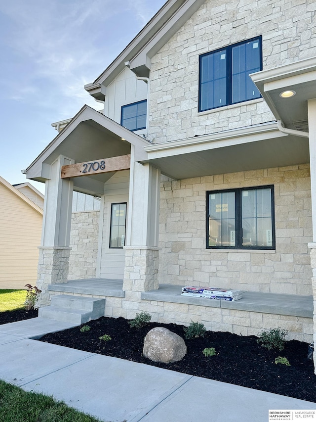 view of exterior entry featuring a porch