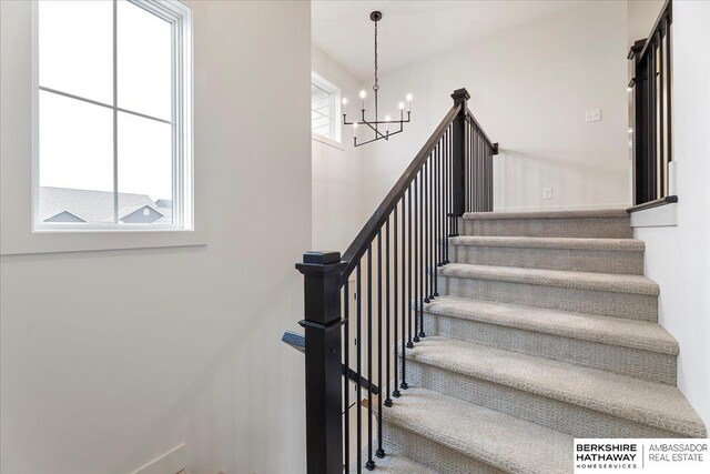 stairway with an inviting chandelier