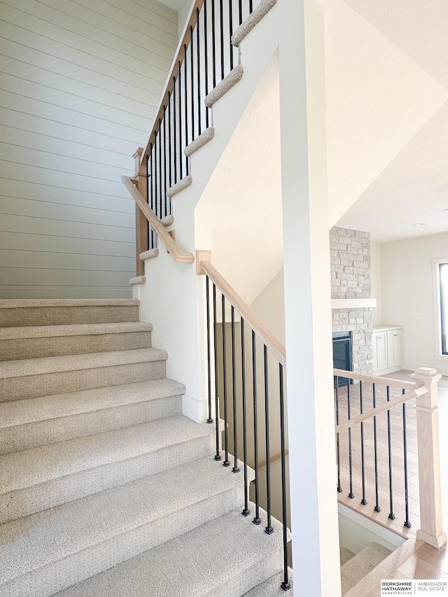 staircase with a fireplace