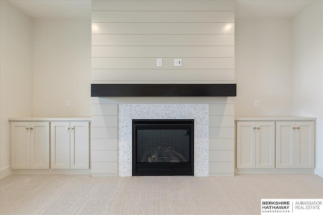 interior details with carpet flooring and a fireplace