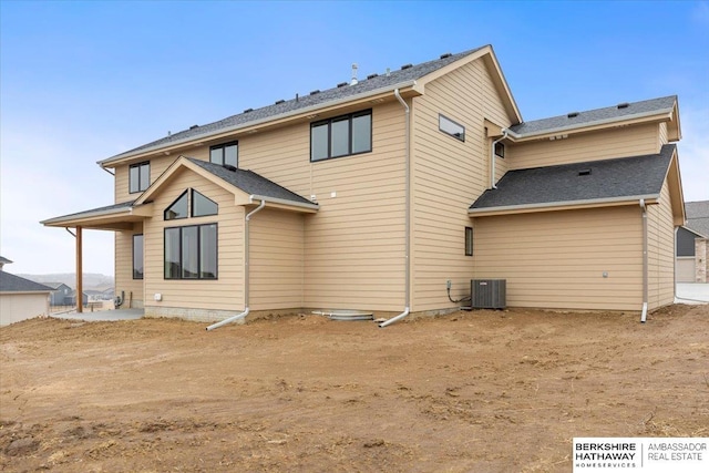 rear view of property featuring central AC unit