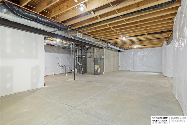 basement featuring gas water heater and heating unit