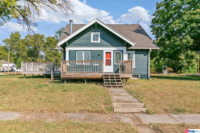 bungalow featuring a deck and a front lawn