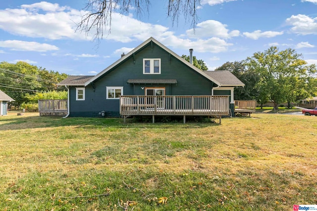 rear view of house with a deck and a lawn