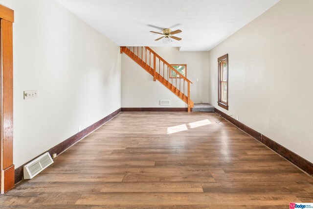 empty room featuring ceiling fan and dark hardwood / wood-style floors