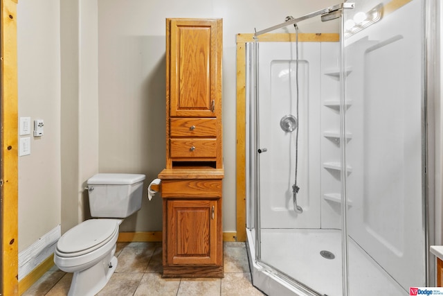 bathroom with toilet, tile patterned flooring, and an enclosed shower