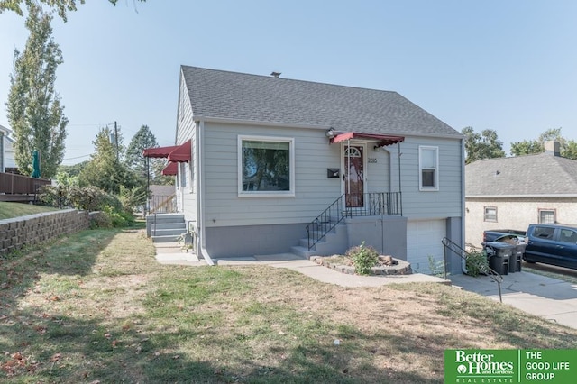 bungalow with a front yard and a garage