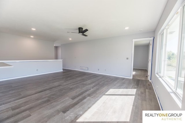 spare room featuring wood-type flooring and ceiling fan