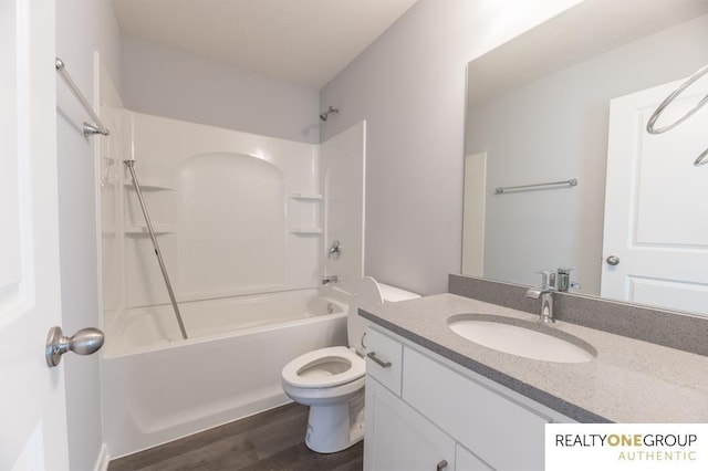 full bathroom with hardwood / wood-style floors, tub / shower combination, vanity, and toilet