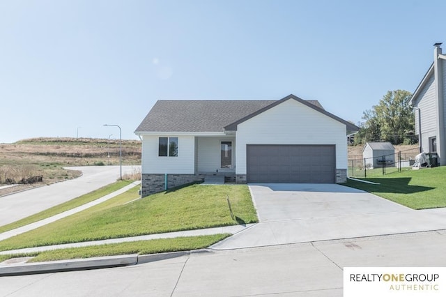 view of front of home with a front yard and a garage