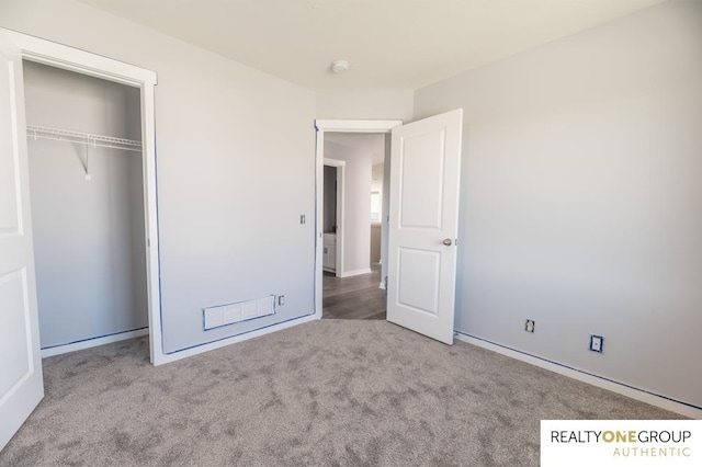 unfurnished bedroom featuring a closet and carpet