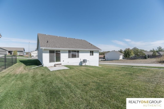 back of property with a patio and a yard