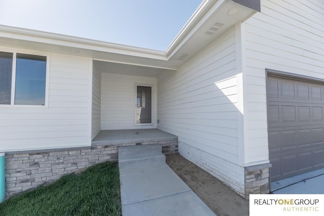 doorway to property featuring a garage