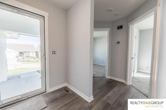 entryway with dark hardwood / wood-style flooring