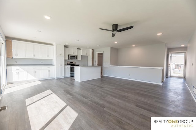 unfurnished living room with ceiling fan and hardwood / wood-style flooring