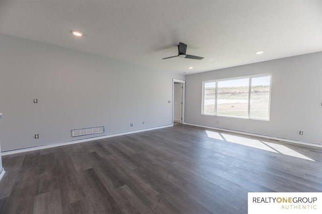 empty room featuring ceiling fan and dark hardwood / wood-style flooring