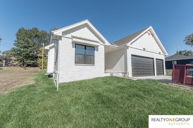 view of front of property with a garage and a front lawn