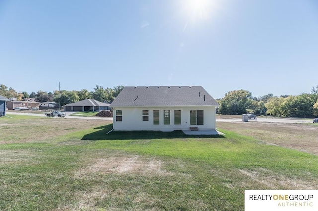 back of property with a lawn