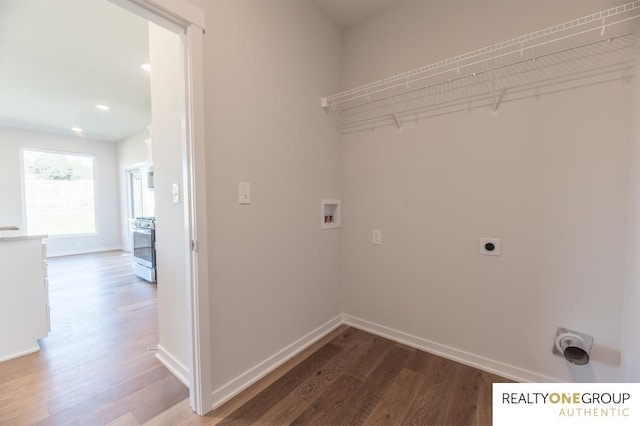 washroom with wood-type flooring, hookup for an electric dryer, and hookup for a washing machine