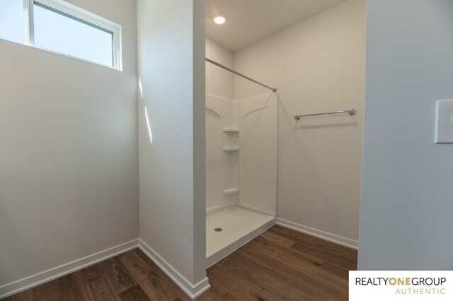 bathroom featuring hardwood / wood-style floors and walk in shower