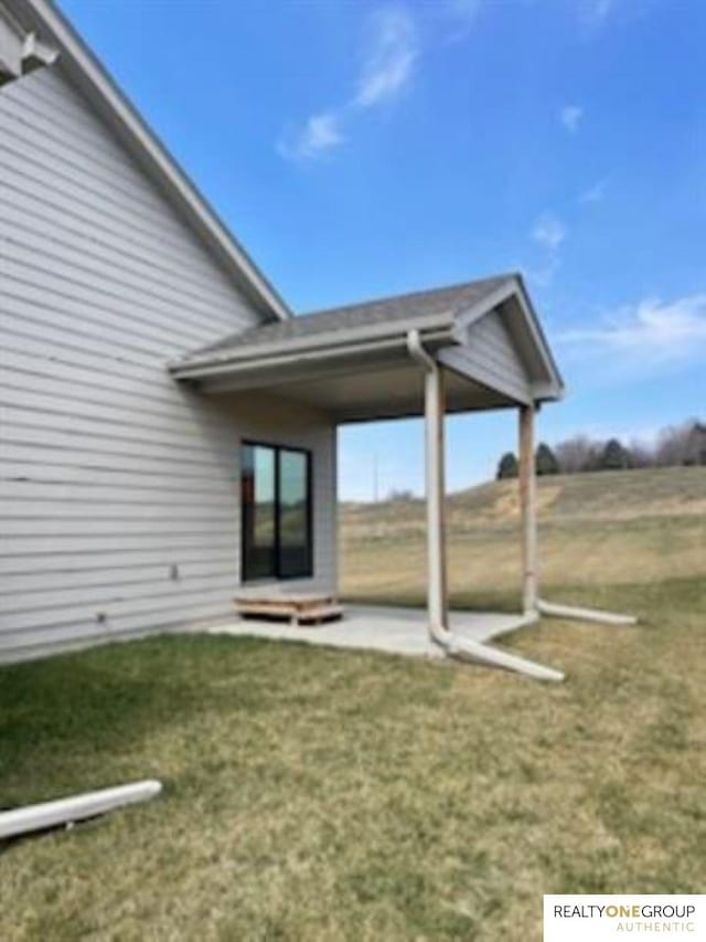 back of house featuring a yard and a patio area