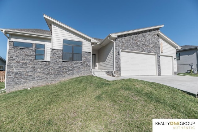 view of front facade featuring a front yard, concrete driveway, stone siding, and a garage