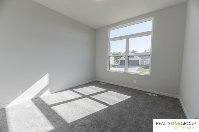 carpeted spare room with baseboards