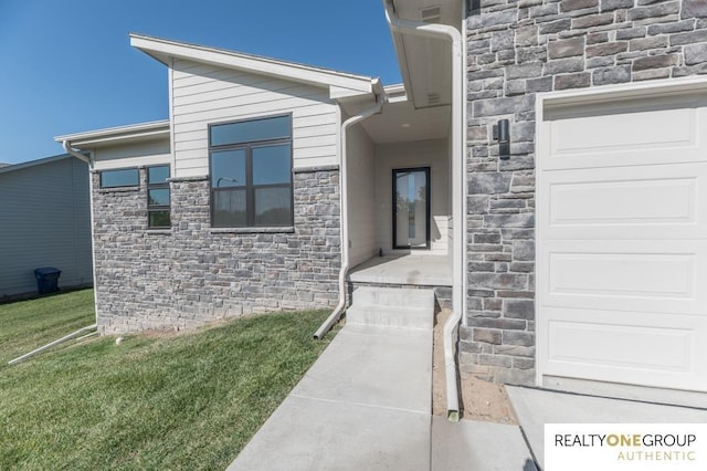 entrance to property with a lawn and stone siding
