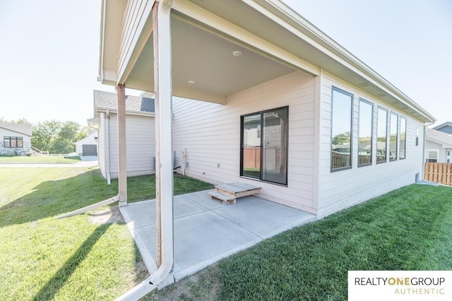 back of property featuring a patio and a yard
