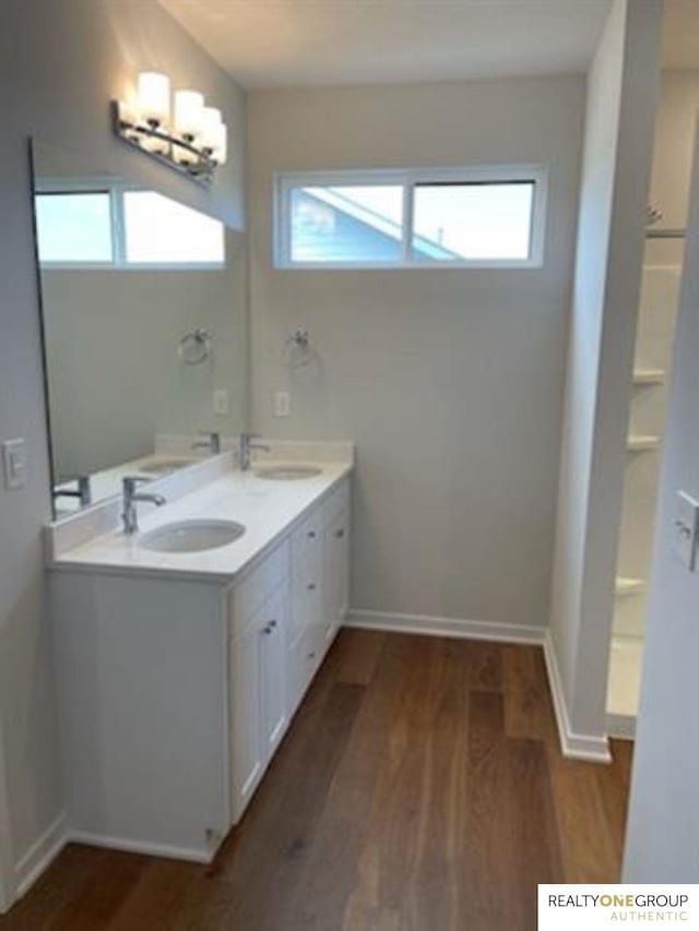 bathroom featuring hardwood / wood-style flooring, plenty of natural light, and vanity