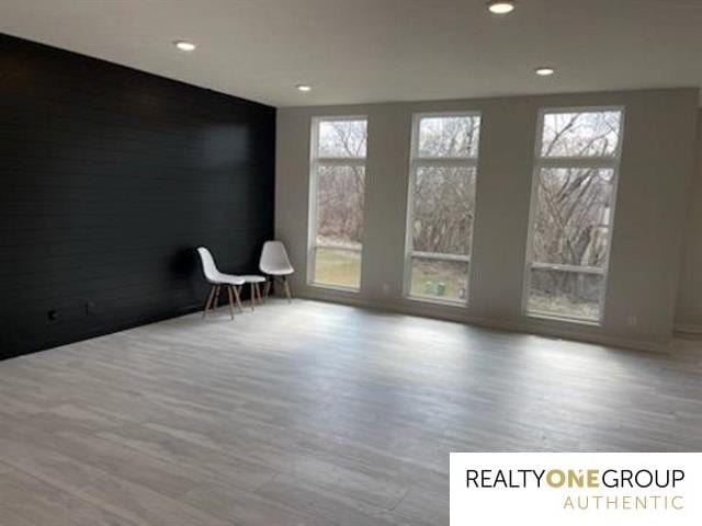 spare room featuring hardwood / wood-style floors and a wealth of natural light