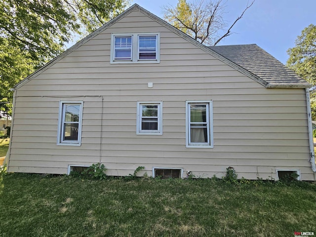 view of property exterior with a yard