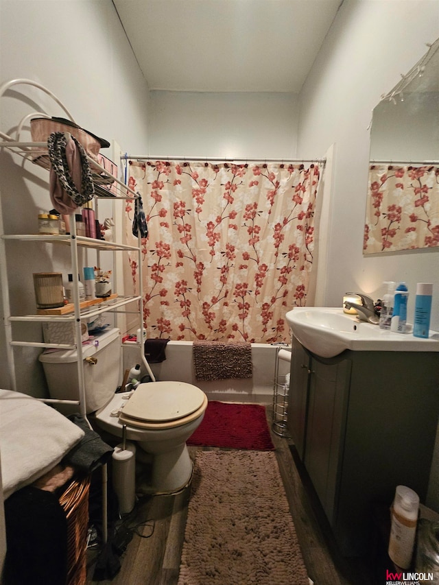 full bathroom with toilet, shower / tub combo with curtain, vanity, and hardwood / wood-style flooring