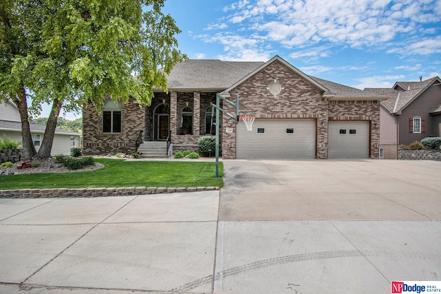 view of front of home with a front lawn and a garage