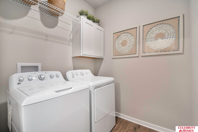 washroom with separate washer and dryer, cabinets, and dark hardwood / wood-style flooring