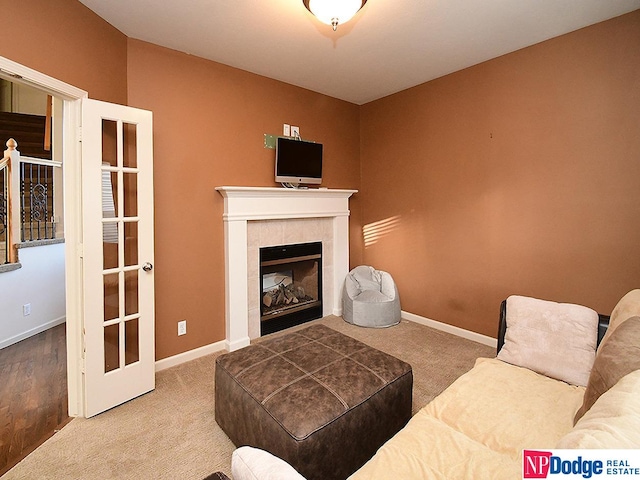 living room with carpet floors and a tiled fireplace