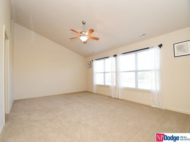 spare room with lofted ceiling, light colored carpet, and ceiling fan