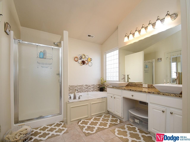 bathroom featuring tile patterned floors, vanity, separate shower and tub, and vaulted ceiling