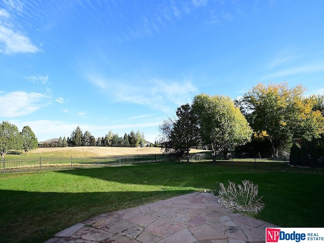 view of yard featuring a rural view and a patio