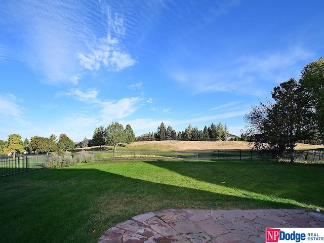 view of yard with a rural view and a patio